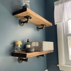 two wooden shelves on the wall in a bathroom