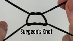 two hands holding a piece of black string with the words surgeon's knot on it