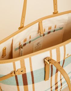 Whether traveling by air, land or sea, this tote will be your favorite new companion. Adjustable side straps allow you to tailor the bag to the size that best suits you. This bag boasts a deep, spacious interior a large zippered pocket on one side and three slip pockets on the other. A beautifully crafted hook closure and signature Spartina mermaid finish the look. Wherever your day takes you, this bag is ready to go! Designer Handwoven Travel Bags, Handwoven Top Handle Shoulder Bag For Travel, Spartina Pectinata, Vacation Tote Shoulder Bag With Gold-tone Hardware, Spartina 449 Handbags, Best Suits, Spartina 449, Work Travel, One Sided