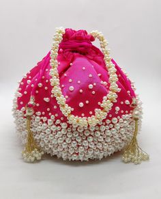 "luxury satin silk pearl embellish drawstring wedding party evening bag for woman | decorative handmade fabric handbag with beaded chain Size: 10\" x 8\" Designed with the heart, this beautiful Potli or batawa bag are eye catchy and made of premium material. Key Features: Art work. This potli is good match with both Indian and western outfits and are superb for wedding and festive parties. This would be best complement to your designer saree, lenhga or any other kind of dress. This is the combin Elegant Pink Handmade Potli Bag, Festival Beaded Potli Bag As A Gift, Elegant Pink Potli Bag For Festivals, Beaded Potli Bag For Festivals And Gifts, Beaded Potli Bag For Festivals Gift, Pearl Embroidered Evening Bag For Festivals, Pearl Embroidery Evening Bag For Festivals, Beaded Potli Bag For Party, Elegant Pink Potli Bag For Gift