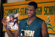 a man holding up a magazine in front of him