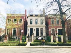 two large brick houses with trees in front of them