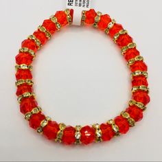 Bracelet Orangey Red Colored Beads With Golden Beads With Embedded Crystals!! Gorgeous Color!! Brand New With Tags! Red Rondelle Jewelry With Large Beads, Red Rondelle Beaded Jewelry, Red Faceted Beads Bracelet, Traditional Red Faceted Beads Bracelet, Red Rondelle Spacer Beads Jewelry, Red Spacer Beads Jewelry For Party, Red Rondelle Beads For Gifts, Red Rondelle Beads For Gift, Red Rondelle Beads Jewelry With Faceted Detail