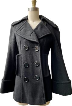 Super unique and timeless fitted black wool double breasted pea coat l. With a large button front closure, front pockets and cool bell shaped sleeves. The nipped in waist and overall construction and tailoring are so flattering, great style and fit.Best fits a size S/MNo defined shoulder29” from collar to sleeve end37” bust31” waist38” hip29” lengthIn great vintage condition, light overall wear and minor pilling but no major flaws Brown Faux Fur Coat, Wool Pea Coat, Pleated Sleeves, Car Coat, Wool Peacoat, Large Buttons, Pea Coat, Faux Fur Coat, Black Wool