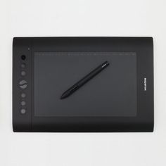 a black tablet with a pen on it