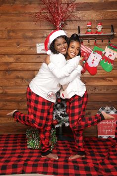 two women in christmas pajamas hugging each other