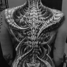 the back of a man with tattoos on his body