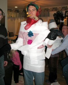 a man dressed as a snowman in a living room with other people around him