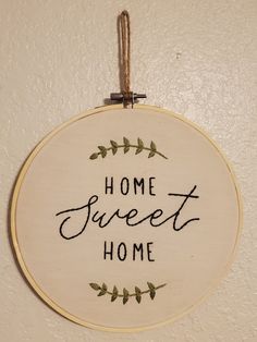 a home sweet home sign hanging on the wall