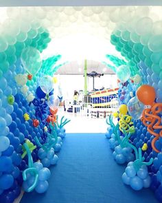 an under the sea themed birthday party with balloons and streamers on blue carpeting