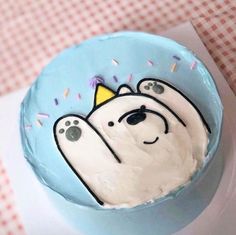 a birthday cake decorated with a polar bear and sprinkles