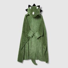 a green dinosaur robe with black horns on it