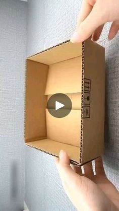 someone is opening the box with their thumb