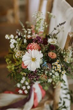 a bouquet of flowers sitting on top of a chair