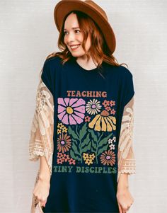 Teaching Tiny Disciples Tshirt/Momming is My Ministry/Motherhood is my Ministry/Homeschool Shirt/Christian Homeschool Mom Christian Mom Gift Crafted from lightweight cotton that is perfect for active wear or leisure, our Teaching Tiny Disciples t-shirt offers comfort and retro style. It's ideal for casual wear, whether going to work, grabbing coffee with friends, or just wanting to wear a comfortable shirt during daily activities. Whether you're curled up on the couch, hanging out with your fami School Spirit Graphic Print Tops For Spring, Spring Graphic Print Top For School Spirit, Homeschool Mom Shirts, Relaxed Fit Tops For School In Spring, Blue Spring Tops With School Spirit Style, Blue Tops For Spring School Spirit, Blue Spring Tops For School Spirit, Blue Relaxed Fit Tops For School, Graphic Tee With Text Print For Teaching