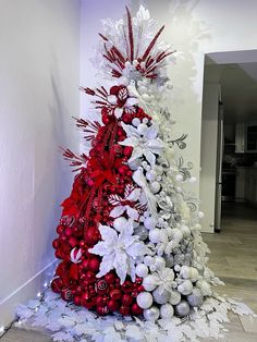 a red and white christmas tree with ornaments