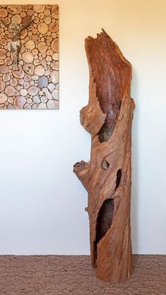 a piece of wood that has been carved into a tree trunk with holes in it