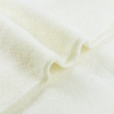 a close up view of a white fabric textured with wool and polyestere