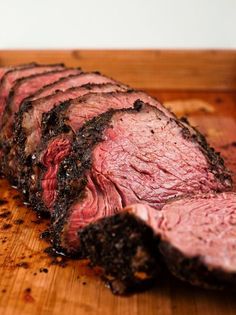 a piece of roast beef on a cutting board with some seasoning in the middle