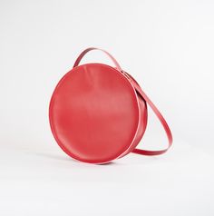 Circular leather shoulder bag. Leather Bags With Adjustable Strap And Round Handle, Modern Crossbody Saddle Bag With Dust Bag, Travel Shoulder Bag With Soft Leather And Round Handle, Modern Bags With Round Handle And Leather Lining, Modern Bags With Leather Lining And Round Handle, Red Shoulder Bag With Round Handle For Daily Use, Modern Bag With Round Handle And Leather Lining, Modern Leather Flap Bag With Round Handle, Travel Shoulder Bag With Leather Lining And Round Handle