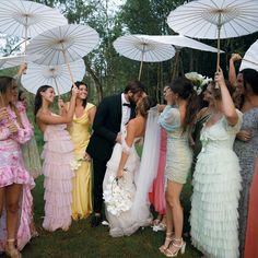 a group of people standing next to each other holding umbrellas