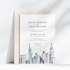 a wedding card with the city skyline drawn on it