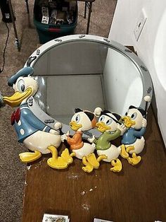 the ducky family is sitting in front of the mirror on the table next to each other