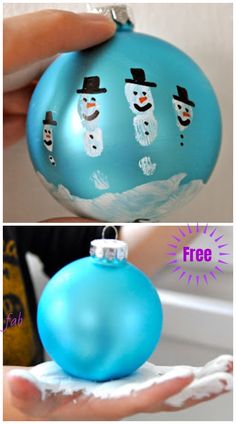 an ornament with snowmen painted on it is being held by someone's hand