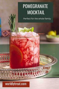 a drink in a glass with ice and garnish on the rim that says, pomegranate cocktail perfect for the whole family