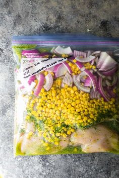 a bag filled with meat and veggies on top of a stone countertop