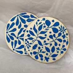 two blue and white plates with leaves on them