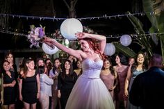 a woman in a wedding dress holding a white ball