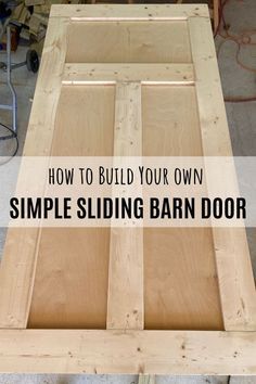 a wooden table with the words how to build your own simple sliding barn door