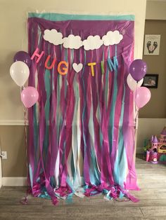 a birthday decoration with balloons and streamers