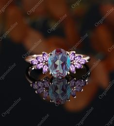 an image of a ring with purple stones on it