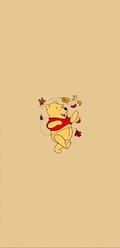 a winnie the pooh wallpaper with autumn leaves on it and an orange scarf around its neck