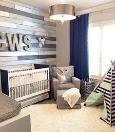 a baby's room decorated in gray, white and blue