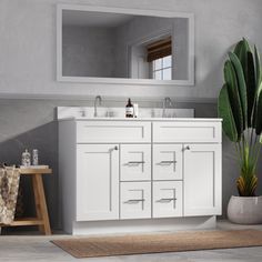 a bathroom with a large mirror above the sink and a rug on the floor next to it