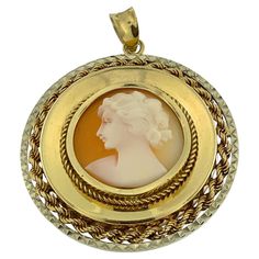 This Vintage Italian Cameo Pendant is a beautifully crafted piece of jewelry that combines the timeless elegance of cameo artistry with intricate goldwork. Made from luxurious 18kt yellow and white gold, this pendant showcases the exceptional craftsmanship and classic design for which Italian jewelry is renowned. The focal point of the pendant is a meticulously carved cameo depicting a woman's profile, rendered with exquisite detail and artistry. The cameo is set against a backdrop of warm yellow gold, which provides a rich contrast to the delicate carving. Surrounding the cameo is a border of hammered white gold, adding a touch of texture and sophistication to the design. The hammered finish creates a unique visual effect, enhancing the pendant's overall appeal and adding a contemporary t Ancient Sumerian, Cameo Jewelry, Warm Yellow, Shopping Photography, Vintage Cameo, Italian Jewelry, Modern Art Deco, Princess Anne, Cameo Pendant