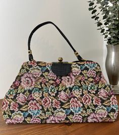 1960s Floral Tapestry Top Handle Convertible Handbag, 60s Vintage Purse, Vintage Accessory  Two in one handbag from the 1960s. The outer cover of the handbag is a floral tapestry that easily snaps off for a sleek black handbag. It has a single black vinyl handle strap. Gold tone metal frame with a thumb lift closure that works well and closes tightly. Opens to a black vinyl lining. Nearest mint condition *the exterior is immaculate.  The lining is immaculate with no stains or holes.  The metal h Vintage Top Handle Evening Bag, Vintage Party Shoulder Bag With Detachable Handle, Vintage Shoulder Bag With Detachable Handle For Party, Vintage Multicolor Bag With Detachable Strap, Vintage Evening Shoulder Bag With Top Carry Handle, Vintage Top Handle Shoulder Bag For Party, Vintage Multicolor Satchel With Removable Pouch, Vintage Multicolor Top Handle Shoulder Bag, Vintage Rectangular Evening Bag With Top Carry Handle