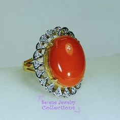 This pretty Levian red Coral Ring is set in 14k solid gold and is surrounded by a diamond halo!Ring Size: 7Total Weight: 9.25 gramsPrecious Metal: 14k solid goldPrecious stones:-Coral Center Stone: 19mm x 14mm, 10 carats-White Round diamonds: 0.2 ctHallmark: 14K, HK Formal Ruby Ring With Diamond And Oval Cabochon Shape, Formal Oval Cabochon Ruby Ring With Diamond, Oval Cabochon Ruby And Diamond Ring, Luxury Red Rings With Diamond Accents, Formal Orange Diamond Ring, Heirloom Oval Cabochon Diamond Ring For Formal Occasions, Formal Yellow Gold Oval Cabochon Diamond Ring, Heirloom Oval Diamond Ring For Formal Occasions, Formal Heirloom Oval Cabochon Diamond Ring