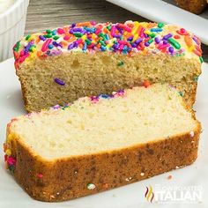 a slice of cake with sprinkles on it sitting on a white plate