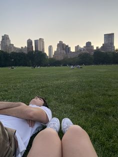 a person laying on the grass in a park