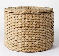 a woven basket with lid is shown on a white background