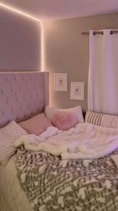 a bed with blankets and pillows on top of it