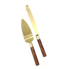 two gold colored knives with wooden handles on a white background, one is cut in half and the other has a wood handle