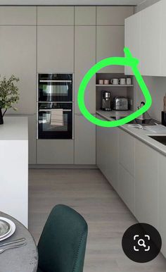 a kitchen with a green clock on the wall