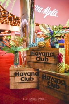 three wooden boxes with pineapples on them sitting on a red carpeted floor