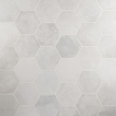 a white tiled wall with hexagonal tiles