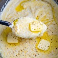 mashed potatoes and butter in a bowl with a spoon